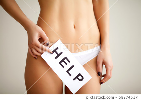 Vaginal or urinary infection and problems concept. Young woman holds paper with SOS above crotch. 58274517