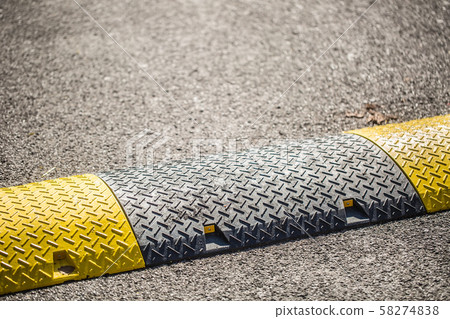 Road bumps to reduce speed - close-up 58274838