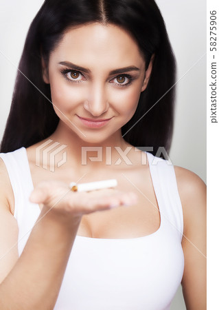 No smoking. The cigarette is broken in the girl's hand. Against smoking The concept of health. On a 58275906