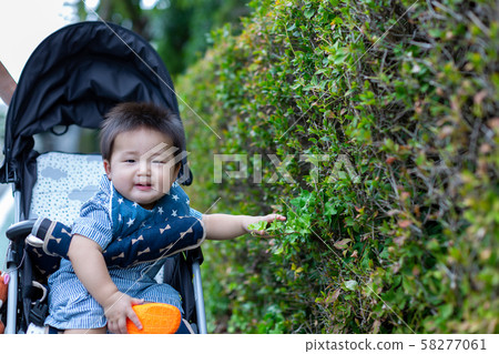 Infant and child in a stroller Infant and child in a stroller 58277061