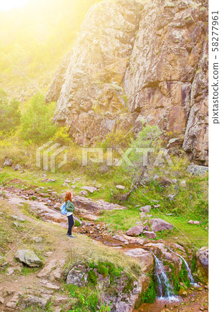Female hiker walking in mountains forest. 58277961