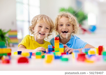 Child playing with toy blocks. Toys for kids. 58278407