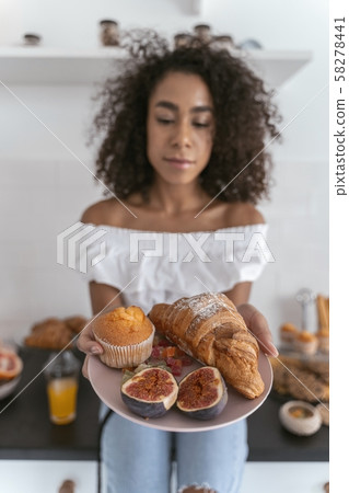 Pretty woman choosing what to eat next Pretty woman choosing what to eat next 58278441