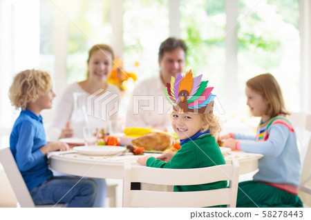 Family with kids at Thanksgiving dinner. Turkey. 58278443