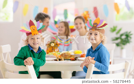 Family with kids at Thanksgiving dinner. Turkey. 58278445
