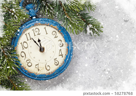 Christmas fir tree and alarm clock over old wood Christmas fir tree and alarm clock over old wood 58278768