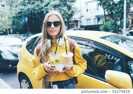 Street portrait of a girl on a background of a car Street portrait of a girl on a background of a car 58279858