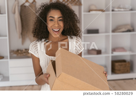 Positive delighted female person looking at camera Positive delighted female person looking at camera 58280029