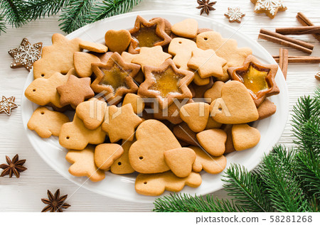 Christmas and culinary background with a plate of freshly baked Christmas gingerbread Christmas and culinary background with a plate of freshly baked Christmas gingerbread 58281268