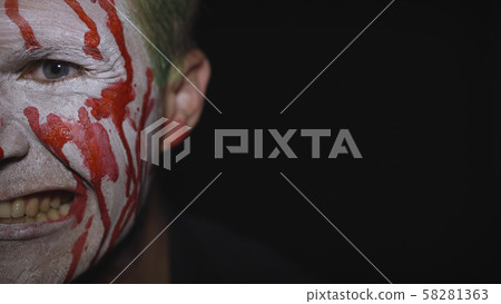 Clown Halloween man portrait. Creepy, evil clowns blood face. White face makeup 58281363