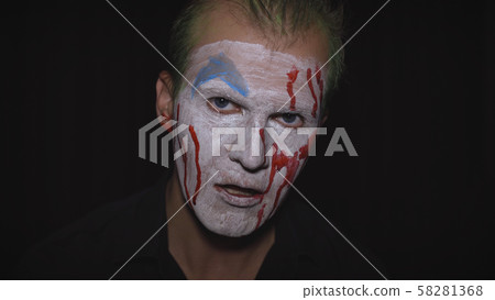 Clown Halloween man portrait. Creepy, evil clowns blood face. White face makeup Clown Halloween man portrait. Creepy, evil clowns blood face. White face makeup 58281368