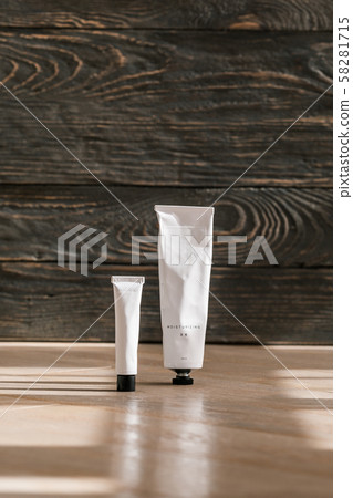 Cosmetic white tube on wooden table 58281715