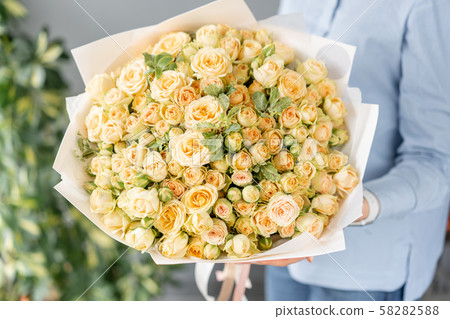 Mono bouquet of spray roses. Delicate bouquet of mixed flowers in womans hands. the work of the Mono bouquet of spray roses. Delicate bouquet of mixed flowers in womans hands. the work of the 58282588