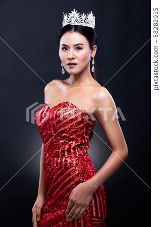 Portrait of Miss Pageant Beauty Contest in Red sequin Evening Ball Gown long dress with sparkle light Diamond Crown, Asian Woman fashion make up black hair style, studio lighting dark background Portrait of Miss Pageant Beauty Contest in Red sequin Evening Ball Gown long dress with sparkle light Diamond Crown, Asian Woman fashion make up black hair style, studio lighting dark background 58282915