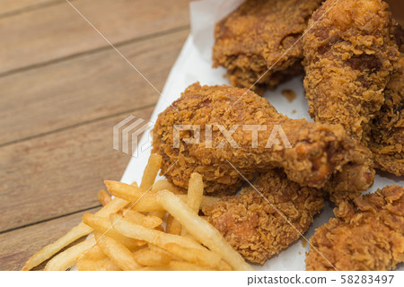 Fried chicken and French fries or chips (potato) Fried chicken and French fries or chips (potato) 58283497