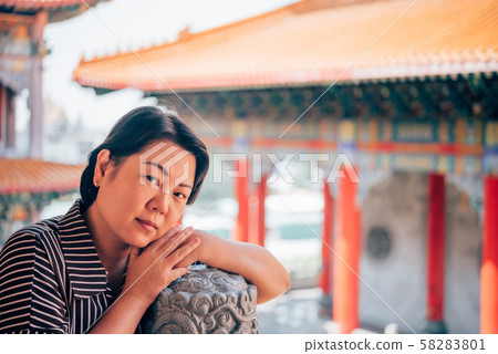 Woman at Wat Boromracha Kanchanapisek Anusorn Woman at Wat Boromracha Kanchanapisek Anusorn 58283801