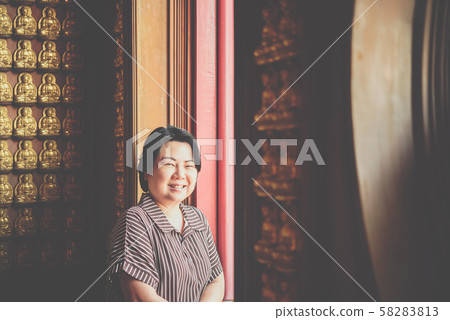 Woman at Wat Boromracha Kanchanapisek Anusorn Woman at Wat Boromracha Kanchanapisek Anusorn 58283813