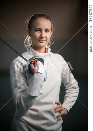 A portrait of a young woman fencer with a singlestick A portrait of a young woman fencer with a singlestick 58287942