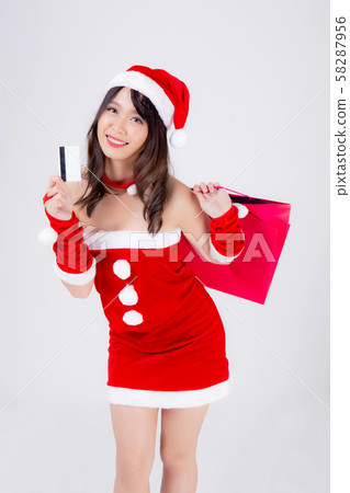 Beautiful portrait young asian woman smiling holding credit card and shopping paper bag with excited Beautiful portrait young asian woman smiling holding credit card and shopping paper bag with excited 58287956
