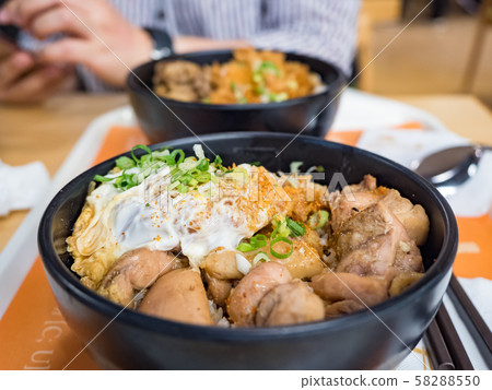 Katsudon is a popular Japanese food, a bowl of rice topped with a deep-fried pork cutlet, egg, vegetables, and condiments. Katsudon is a popular Japanese food, a bowl of rice topped with a deep-fried pork cutlet, egg, vegetables, and condiments. 58288550