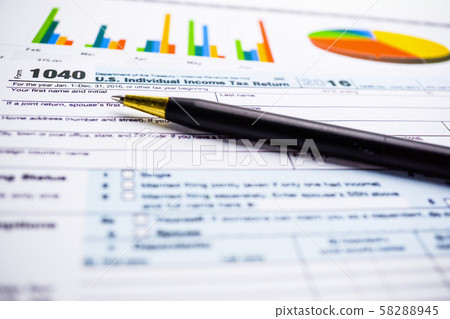 Tax Return form 1040 and dollar banknote 58288945