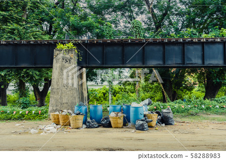 The area that dumped garbage under The Bridge of the River Kwai in Kanchanaburi, Thailand. pollution garbage waste, lots of junk dump, plastic garbage waste is environment pollution. The area that dumped garbage under The Bridge of the River Kwai in Kanchanaburi, Thailand. pollution garbage waste, lots of junk dump, plastic garbage waste is environment pollution. 58288983