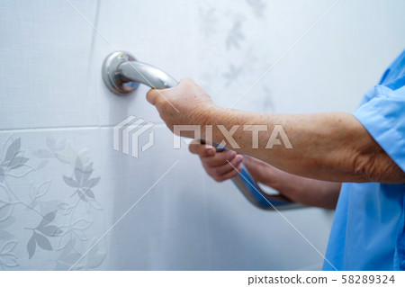 Asian senior or elderly old lady woman patient use toilet bathroom handle security in nursing hospital ward Asian senior or elderly old lady woman patient use toilet bathroom handle security in nursing hospital ward 58289324