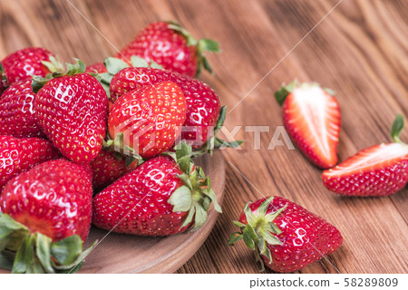 Ripe fresh strawberries in Minsk on a wooden table Ripe fresh strawberries in Minsk on a wooden table 58289809
