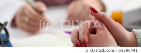 Female doctor hand hold silver pen 58290441