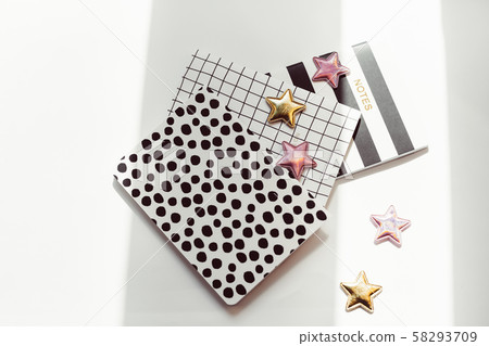 Desktop feminine composition. Notepads and stars Desktop feminine composition. Notepads and stars 58293709