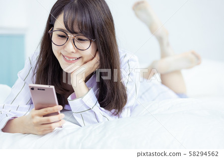 Female Smartphone, Bedroom Wear, Smile 58294562