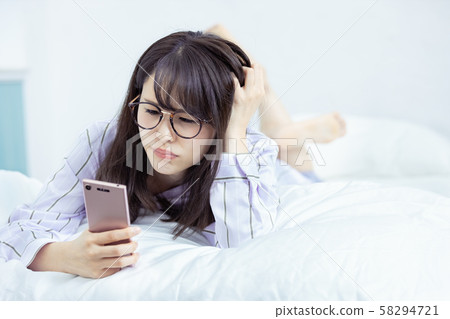 Female Smartphone Displeased Bedroom Female Smartphone Displeased Bedroom 58294721