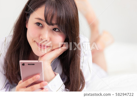 Female Smartphone, Bedroom Wear, Smile 58294722