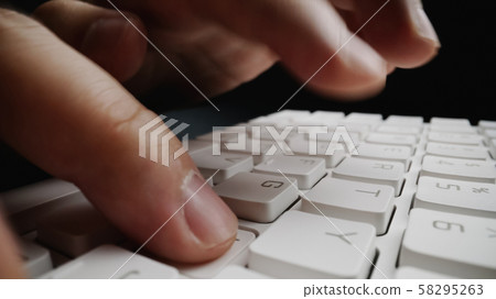 Close-up soft-focus finger typing on keyboard. Close-up soft-focus finger typing on keyboard. 58295263