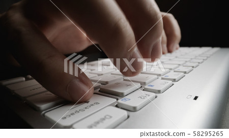 Close-up soft-focus finger typing on keyboard. Close-up soft-focus finger typing on keyboard. 58295265