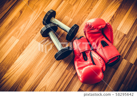 Red boxing gloves on a wood background. Red boxing gloves on a wood background. 58295642