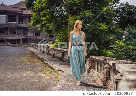 Woman tourist in abandoned and mysterious hotel in Bedugul. Indonesia, Bali Island. Bali Travel 58300957