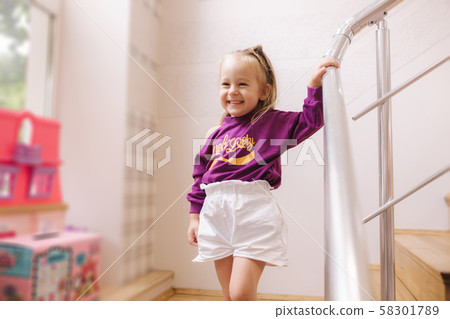 Happy little girl walkning in toy store. Cute girl choose toy. Adorable female in kids mall Happy little girl walkning in toy store. Cute girl choose toy. Adorable female in kids mall 58301789