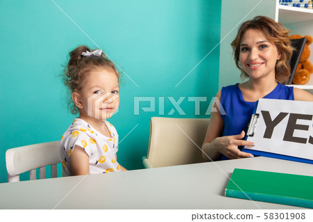 Female psychologist counseling little girl in the cabinet. 58301908
