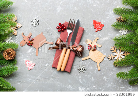 Top view of flatware tied up with ribbon on napkin Top view of flatware tied up with ribbon on napkin 58301999