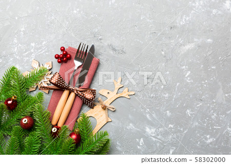 Top view of flatware tied up with ribbon on napkin Top view of flatware tied up with ribbon on napkin 58302000