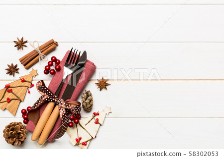 Top view of fork and knife tied up with ribbon on 58302053