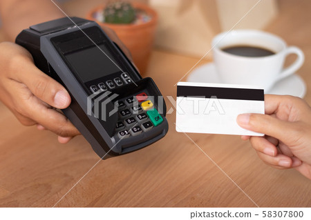 hand of customer using credit cart for payment at point of sale terminal in shop during shopping time, cashless technology and credit card payment concept 58307800