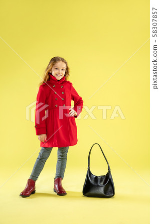 A full length portrait of a bright fashionable girl in a raincoat 58307857