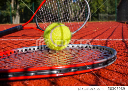 Tennis scene with net shadow, ball and racquet 58307989