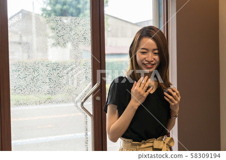 Young woman using hands-free fan Young woman using hands-free fan 58309194