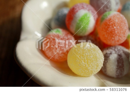 Colorful candy on a ceramic plate 58311076