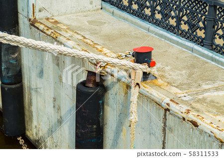 Mooring bollard with mooring ropes 58311533