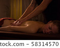 Masseur doing back massage for female client in spa center 58314570