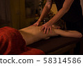 Professional male masseur doing massage for female client at spa salon 58314586